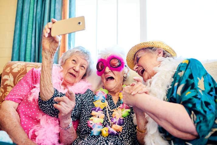 Three senior girlfriends having fun at a seniors home